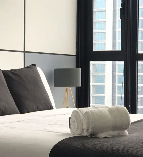 Hotel bed with folded towels